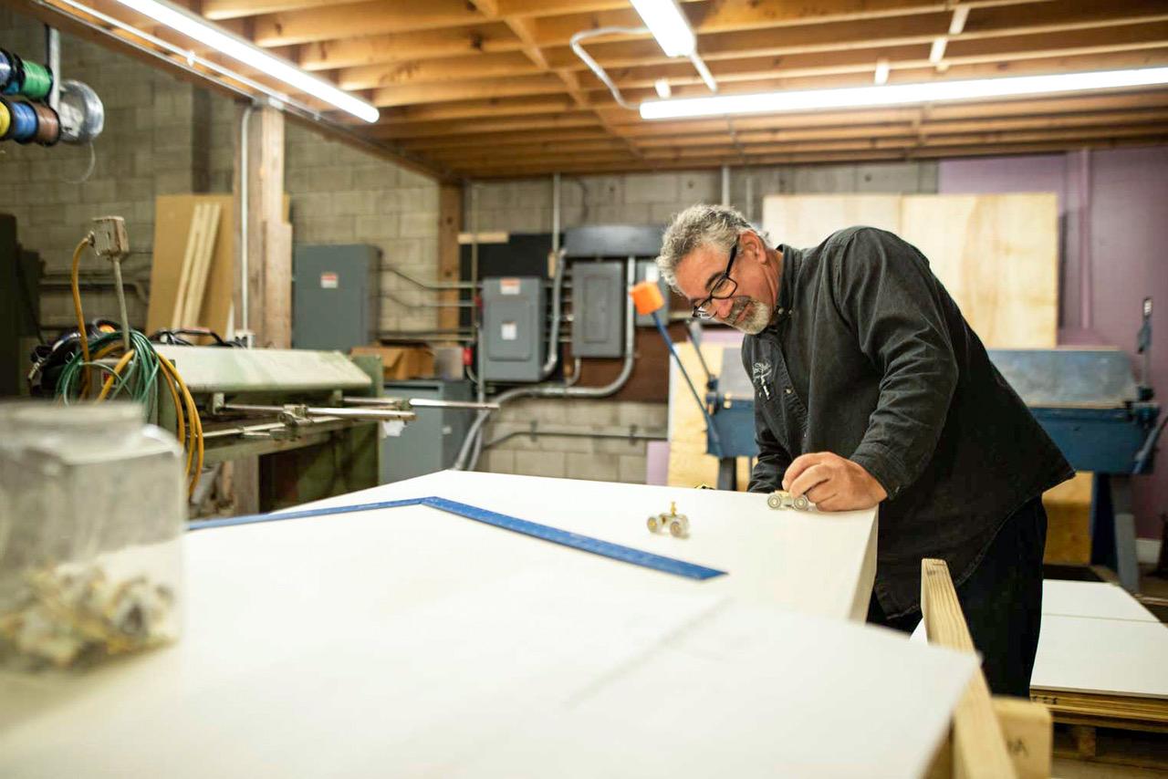 Don Lake, co-founder of RootCellar works on custom door